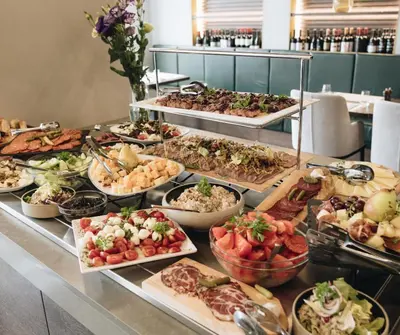 a buffet line with many different types of food at Pegaz Holiday Resort in Vrnjačka Banja