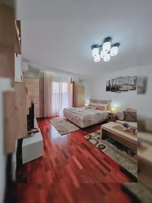 a living room with a bed and a couch at Apartman Temida Lux in Vrnjačka Banja