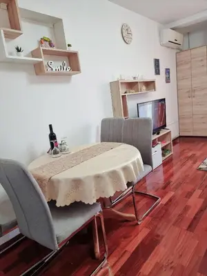 a dining room with a table and two chairs at Apartman Temida Lux in Vrnjačka Banja