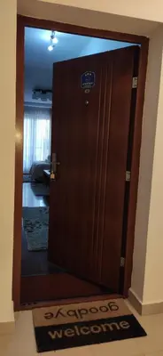 a wooden door with a welcome sign on it at Apartman Temida Lux in Vrnjačka Banja