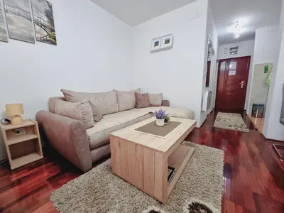 a living room with a couch and a coffee table at Apartman Temida Lux in Vrnjačka Banja