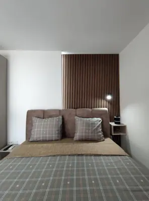 a bedroom with a bed with two pillows on it at Nikolic Apartment 2 in Leskovac