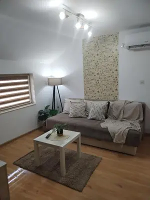 a living room with a couch and a table at STEFAN in Vrnjačka Banja