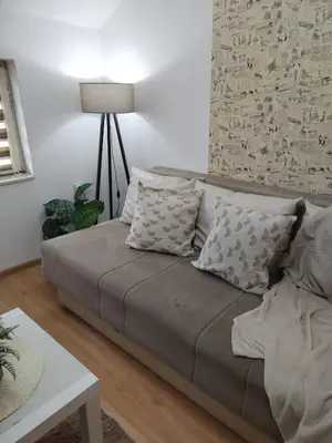 a couch with pillows in a living room at STEFAN in Vrnjačka Banja
