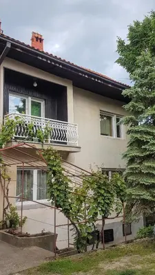 a house with a balcony on the side of it at Apartmani Smiljanic Sokobanja in Soko Banja
