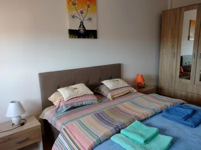 a bedroom with a bed with two towels on it at Apartman Dana in Soko Banja