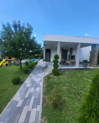 a house with a garden and a walkway at Duos East in Soko Banja