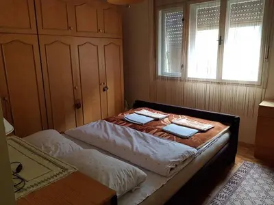 a bedroom with two beds and a table at Vila Happy Story in Knjazevac.