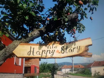 a wooden sign hanging from a tree at Vila Happy Story in Knjazevac.