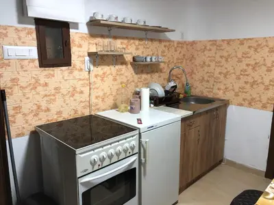 a small kitchen with a stove and a sink at Vila Happy Story in Knjazevac.