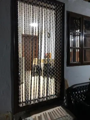 a door with a window with a metal gate at Vila Happy Story in Knjazevac.