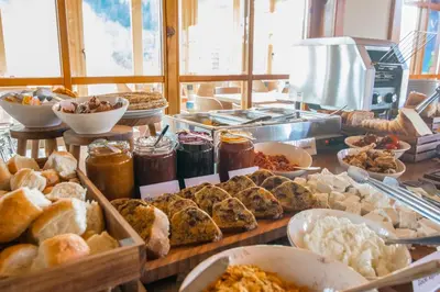 a buffet filled with different types of bread and pastries at Kedar selo Goč in Goč