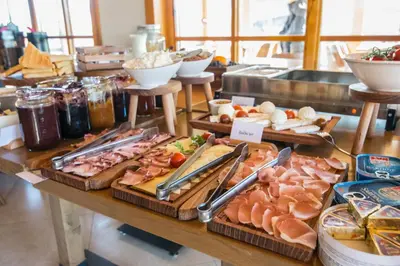 a table filled with lots of different types of food at Kedar selo Goč in Goč