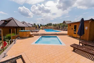 a patio with two pools and two chairs and an umbrella at Kedar selo Goč in Goč