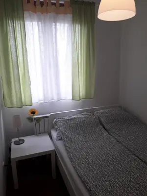 a small bedroom with a bed and a window at Raj Pegaz in Vrnjačka Banja