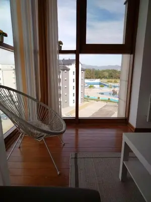 a chair in a room with a large window at Raj Pegaz in Vrnjačka Banja