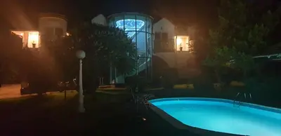 a night picture of a swimming pool in a house at Veliki Raj Plus in Stenjevac