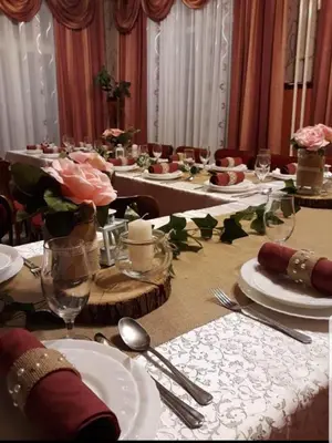 a long table with plates and utensils on it at Veliki Raj Plus in Stenjevac