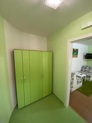 a room with green cabinets and a bedroom at Veliki Raj Plus in Stenjevac