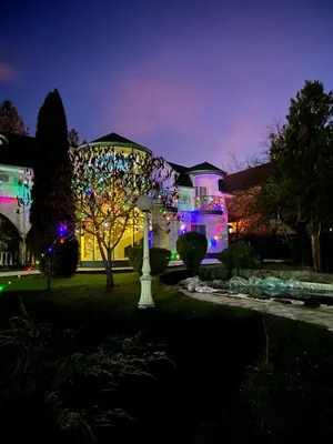 a house with christmas lights in the yard at Veliki Raj Plus in Stenjevac