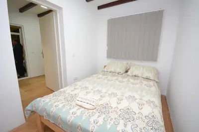 a bedroom with a bed with two pillows on it at Comfort Inn Apartmani in Vrnjačka Banja