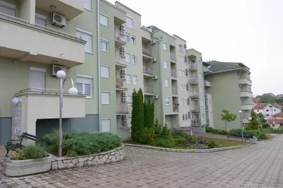 a row of apartment buildings on a brick street at Apartman NEDA - 5 minuta od centra in Vrnjačka Banja