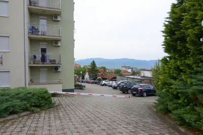 a parking lot with cars parked next to a building at Apartman NEDA - 5 minuta od centra in Vrnjačka Banja