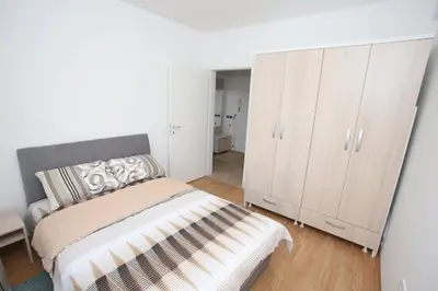 a bedroom with a bed and a white cabinet at Fast Sleep & Go 3 in Paraćin