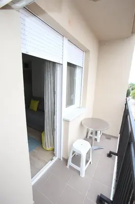 a small balcony with a table and a bed at Fast Sleep & Go 3 in Paraćin