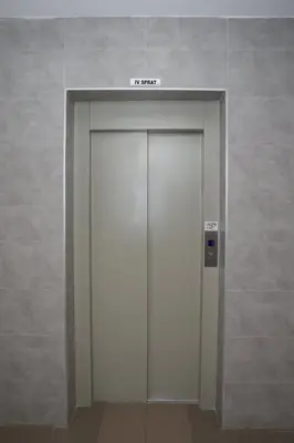 a elevator door in a building with a sign on it at Fast Sleep & Go 3 in Paraćin
