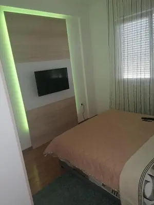 a bedroom with a bed and a flat screen tv at Fast Sleep & Go 3 in Paraćin