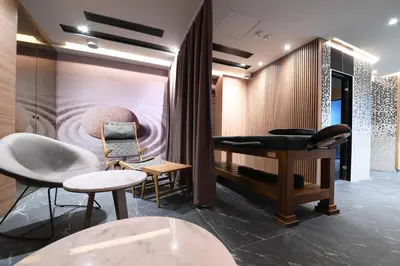 a salon with a table and chairs in a room at Hotel Royal Putnik in Vranje