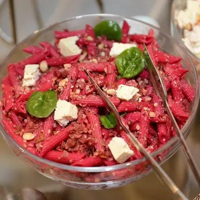 a salad with meat and cheese in a bowl with chopsticks at Hotel Royal Putnik in Vranje