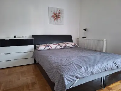 a small bedroom with a bed and a dresser at Studio Apartman NENA in Vrnjačka Banja