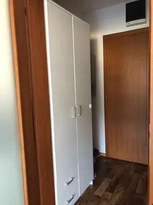 a room with a white cabinet and a door at Studio Apartman NENA in Vrnjačka Banja