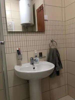 a bathroom with a white sink and a mirror at Studio Apartman NENA in Vrnjačka Banja