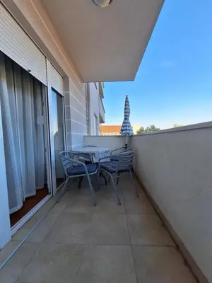a patio with a table and chairs on a balcony at Studio Apartman NENA in Vrnjačka Banja