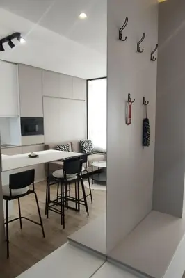 a white kitchen with chairs and a table in a room at Lola apartman Milmari & Residence Hill in Kopaonik
