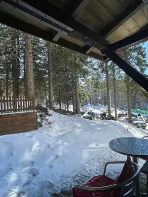 a patio with a table and snow covered ground at Apartman sa terasom Vila Mina Kopaonik in Kopaonik
