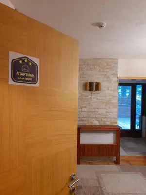 a door to a room with a sign on it at Apartman sa terasom Vila Mina Kopaonik in Kopaonik