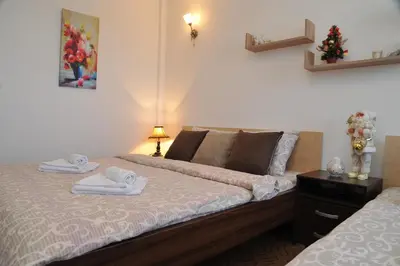 a bedroom with a bed with towels on it at Apartmani Pavlović in Kopaonik