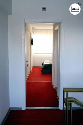 a door to a room with a red carpet at Rooms S&S Milicevic u strogom centru Aleksandrovca in Aleksandrovac