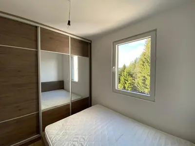 a bedroom with a bed and a window at Silver Hill apartment in Kopaonik