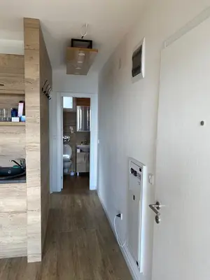 a hallway with a white door and a bathroom at Silver Hill apartment in Kopaonik