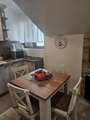 a kitchen with a table with a bowl of fruit on it at KOP P95 Milmari in Kopaonik