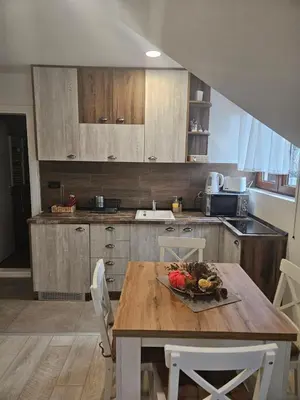a kitchen with a table with a bowl of fruit on it at KOP P95 Milmari in Kopaonik
