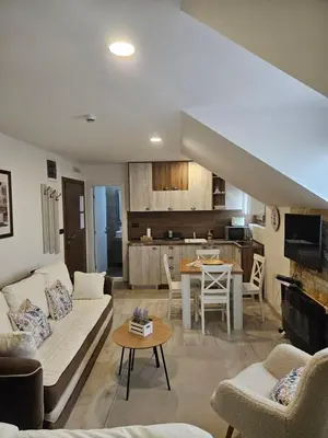 a living room with a couch and a table at KOP P95 Milmari in Kopaonik