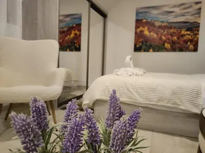 a bedroom with purple flowers and a bed at KOP P95 Milmari in Kopaonik