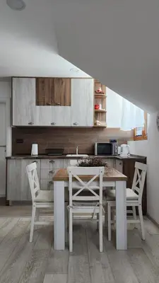 a kitchen with a table and chairs in a kitchen at KOP P95 Milmari in Kopaonik