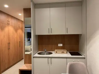 a kitchen with white cabinets and a sink at Kopaonik Centar Konaci in Kopaonik